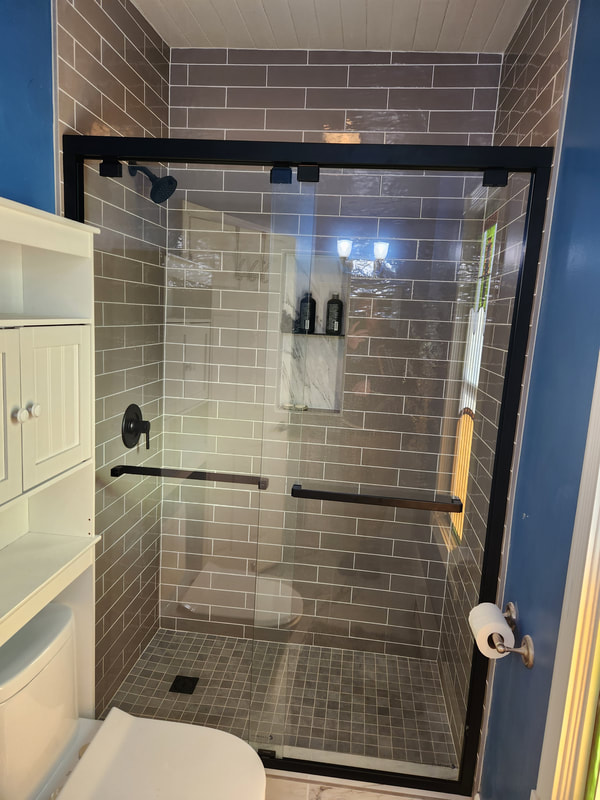 Beautiful tile shower, lifetime warranty.  Semi- frameless bypass glass shower door.  Complete bathroom remodel.