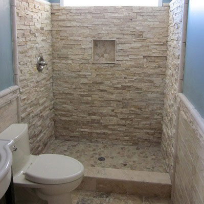 Natural stone tile shower replaced an old cast iron bathtub.
